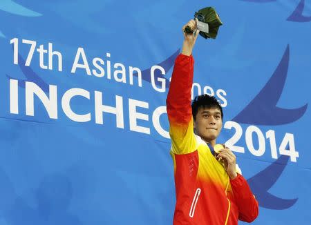 Gold medallist Sun Yang of China reacts on the podium at an award ceremony after winning the men's 400m freestyle final swimming competition at the Munhak Park Tae-hwan Aquatics Center during the 17th Asian Games in Incheon September 23, 2014. REUTERS/Tim Wimborne
