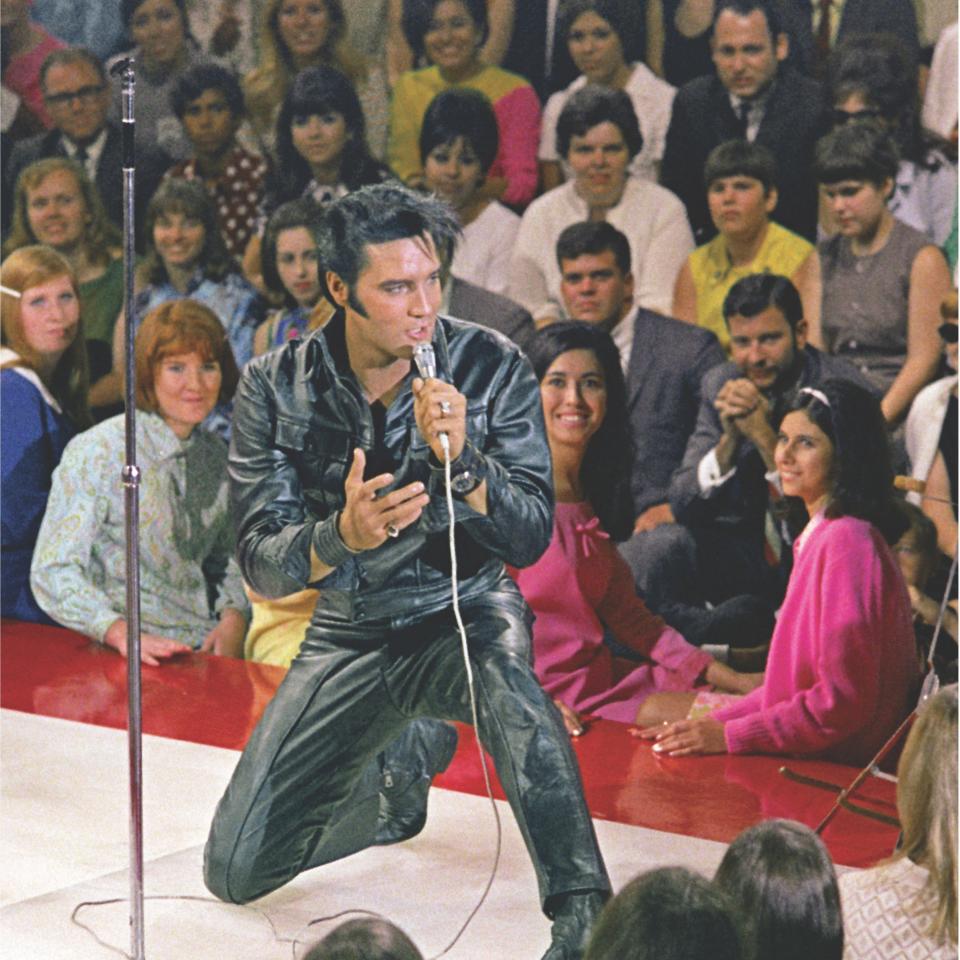 Elvis Presley drops to his knees during a medley of his greatest hits filmed during the 1968 "Singer Special." The black leather suit he is wearing was commissioned after Elvis showed Steve Binder a photo of Marlon Brando in a black leather jacket in the movie "The Wild One."