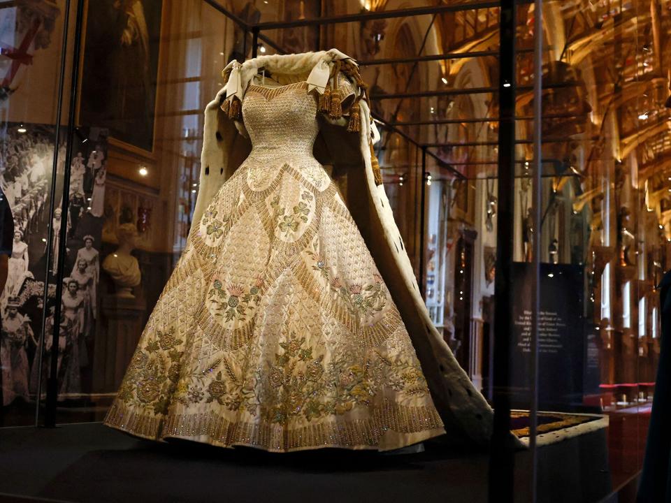 The Coronation Dress and Robe of Estate, worn by Britain's Queen Elizabeth II on her 1953 coronation, and designed by Norman Hartnell and Ede &amp; Ravenscroft respectively, are pictured during a press preview for the Platinum Jubilee - The Queens Coronation exhibition, in St George's Hall at Windsor Castle in Windsor on July, 6, 2022