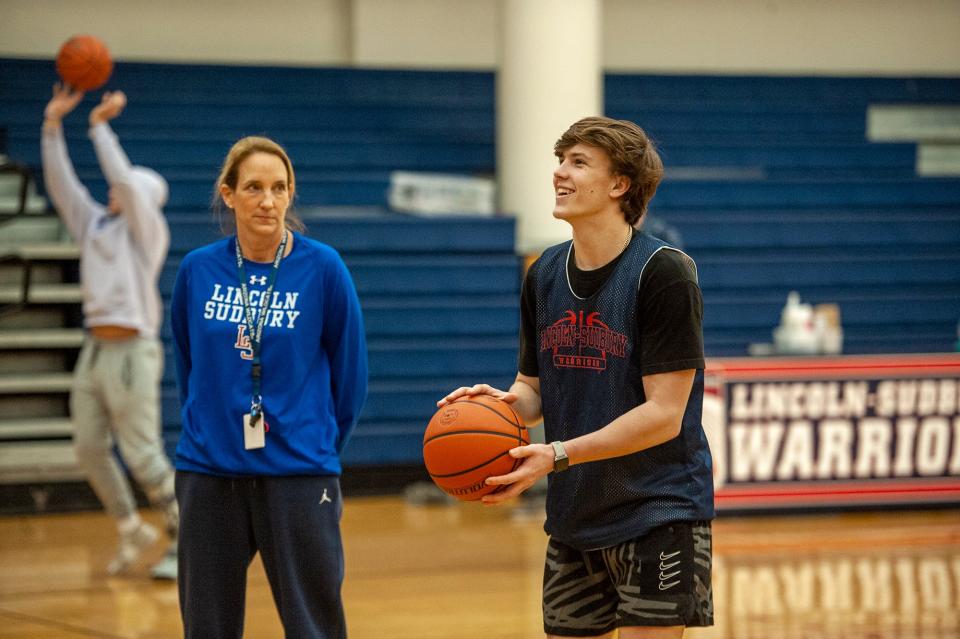 Lincoln-Sudbury sophomore Nolan Martindale takes free throws at practice with his mother, head coach Linda Martindale, looking on, Jan. 12, 2023.