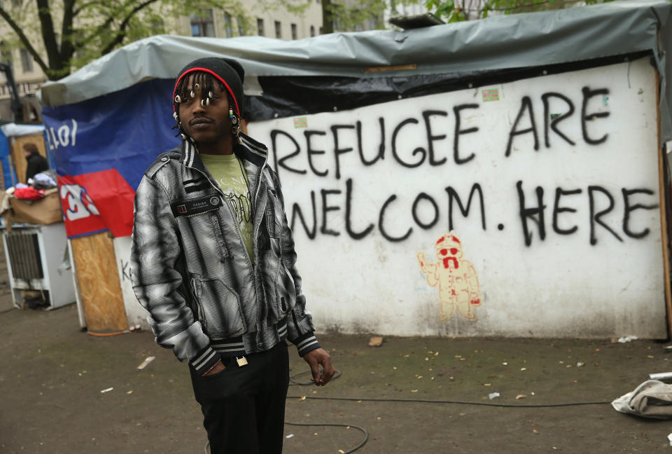 BERLIN, GERMANY - APRIL 08:  A refugee from Niger stands by near huts that were being torn down at a temporary, city-tolerated refugee camp at Oranienplatz in Kreuzberg district on April 8, 2014 in Berlin, Germany. Refugees, many of them from Africa who came to Germany via Lampedusa, began dismantling their shelters today after many of them agreed to a deal with city authorities to move to a renovated hostel. Not all of the several hundred refugees, some of whom have been living at the Oranienplatz camp almost a year, have agreed to the deal, and while some said they will go elsewhere, some insist they will stay, despite a city order to vacate.  (Photo by Sean Gallup/Getty Images)