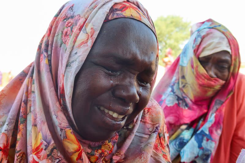 Women from the West Darfur cry after receiving the news about the death of their relatives, in Chad