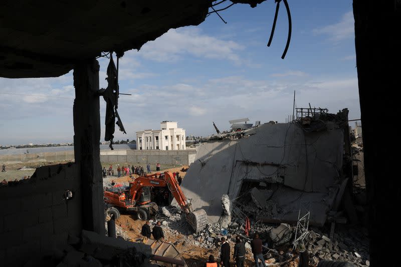 Palestinians inspect a house hit by an Israeli strike, in Rafah in the southern Gaza Strip