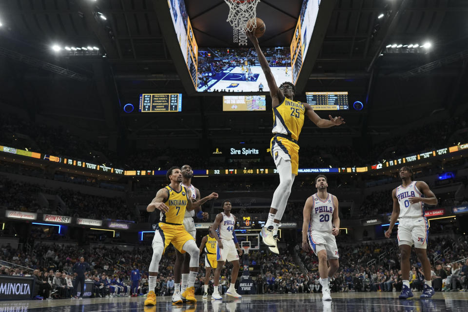 Indiana Pacers forward Serge Ibaka (25) shoots in front of Philadelphia 76ers forward Georges Niang (20) and guard Tyrese Maxey (0) during the first half of an NBA basketball game in Indianapolis, Saturday, March 18, 2023. (AP Photo/AJ Mast)