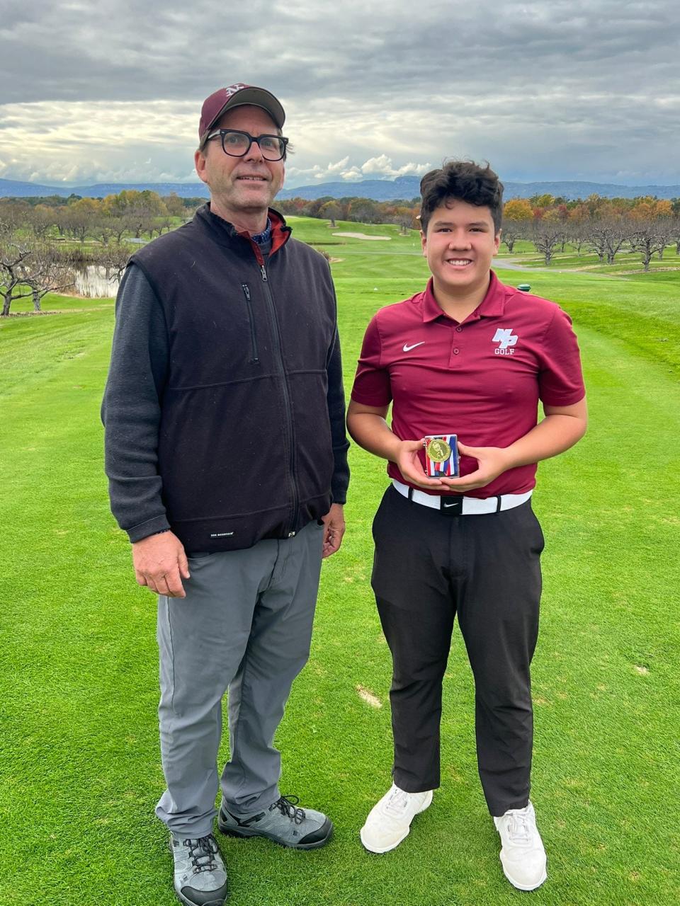New Paltz's Loyal Goodermote poses alongside coach Kieran Bell after winning the Mid Hudson Athletic League boys golf championship on Oct. 18, 2023.
