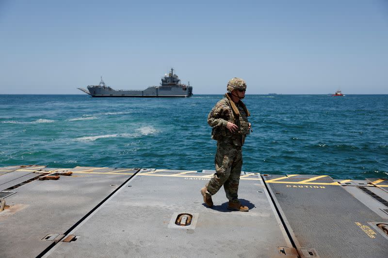 Soldiers stand at Trident Pier