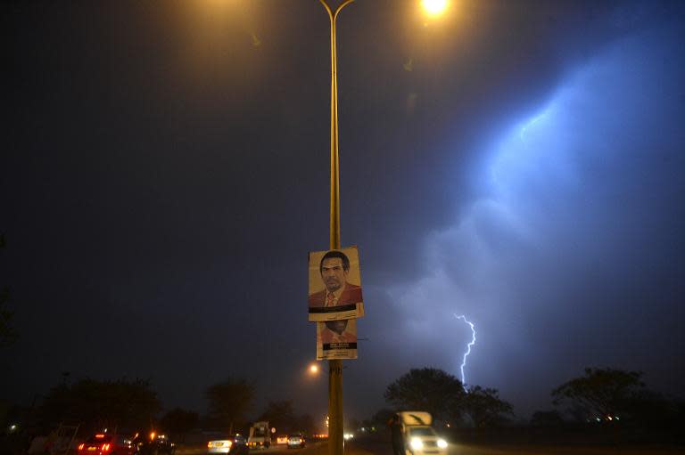 A poster of the incumbent president and leader of the Botswana Democratic Party (BDP) Lt . Gen. Seretse Khama Ian Khama, hangs from a street pole during a thunderstorm on October, 23 2014 in Gaborone, on the eve of the general elections