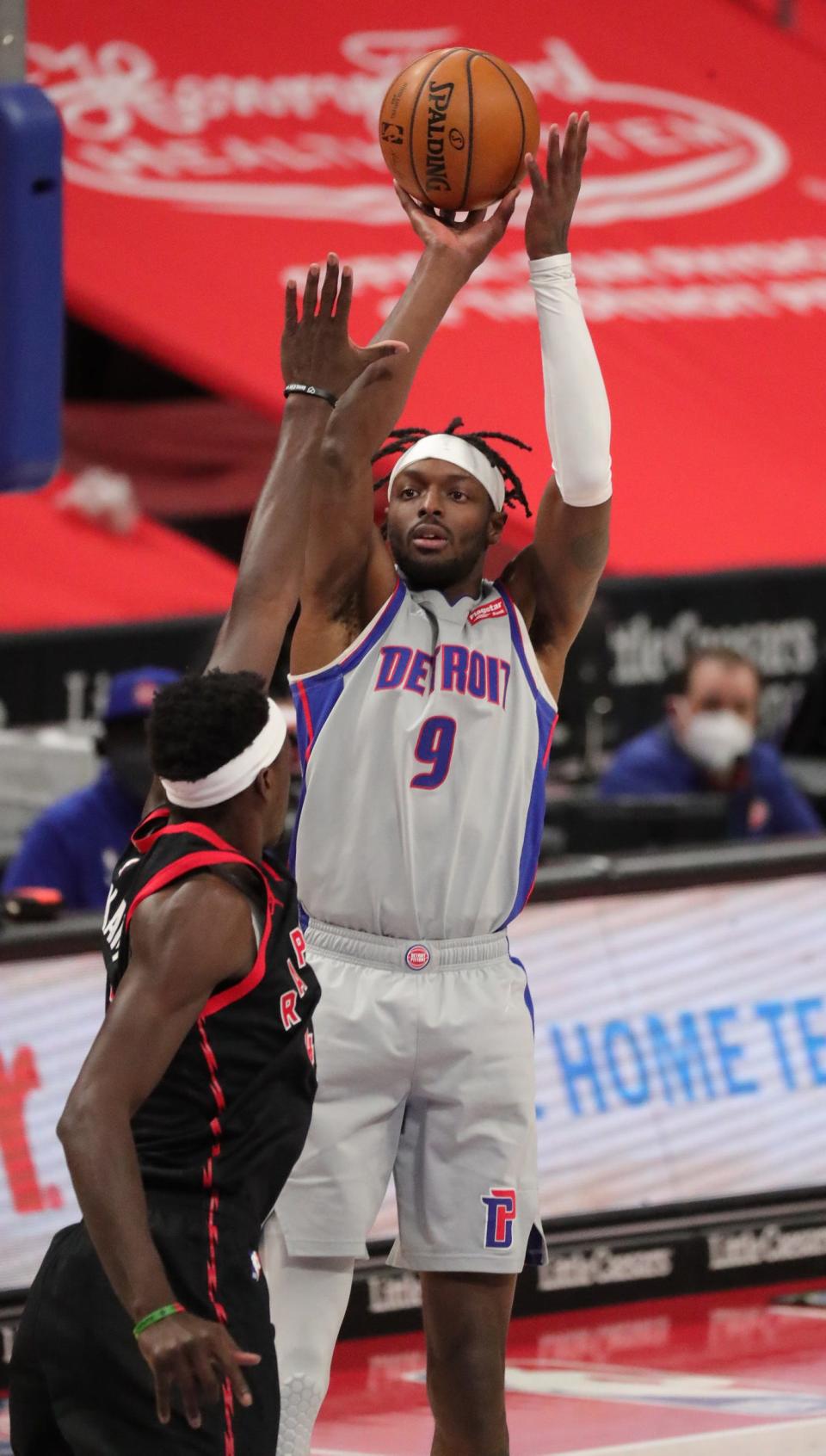 Pistons forward Jerami Grant shoots over Raptors forward Pascal Siakim on Monday, March 29, 2021 at Little Caesars Arena.