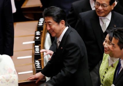 Prime Minister Shinzo Abe talks with other lawmakers after attending the opening of a session of parliament in Tokyo, Japan January 22, 2018. REUTERS/Kim Kyung-Hoon