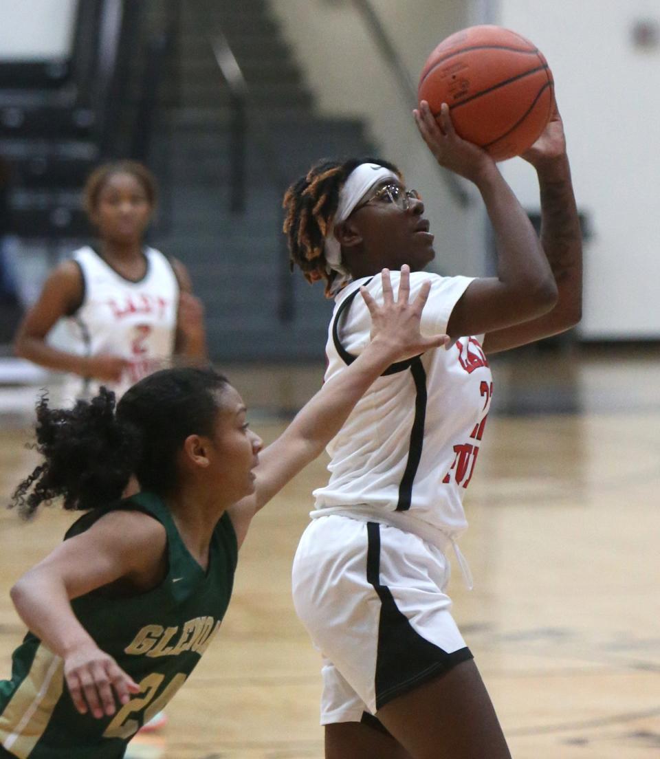 Leilani McNeill (right) of McKinley takes a shot while being defended by Breezie Williams (24) of GlenOak during their game at McKinley on Wednesday.