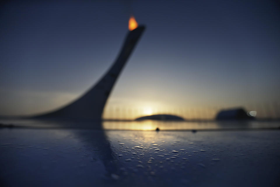 Drops of water sit along the edge of the pool at the Olympic cauldron as the sun sets at the 2014 Winter Olympics, Friday, Feb. 21, 2014, in Sochi, Russia. (AP Photo/David Goldman)