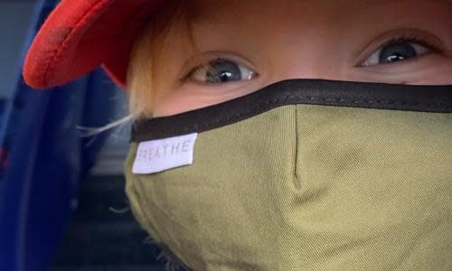 A boy wears a face mask on a bus during the coronavirus crisis