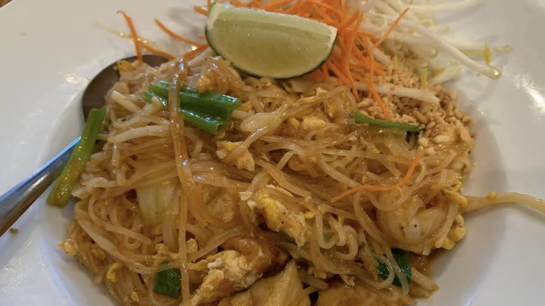 plate of pad thai with lime peanuts