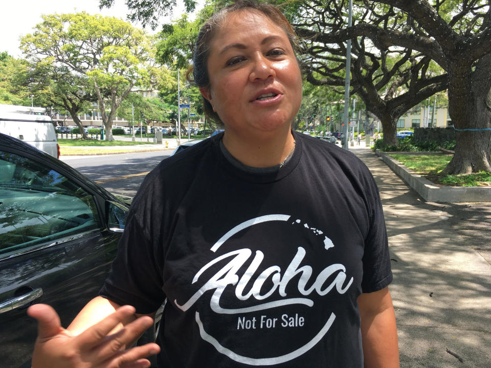 This Friday, April 12, 2019 photo shows Healani Sonoda-Pale, chairwoman of the Ka Lahui Hawaii political action committee, wearing a T-shirt saying "Aloha Not for Sale" in Honolulu. Hawaii lawmakers are considering adopting a resolution calling for the creation of legal protections for Native Hawaiian cultural intellectual property. (AP Photo/Audrey McAvoy)