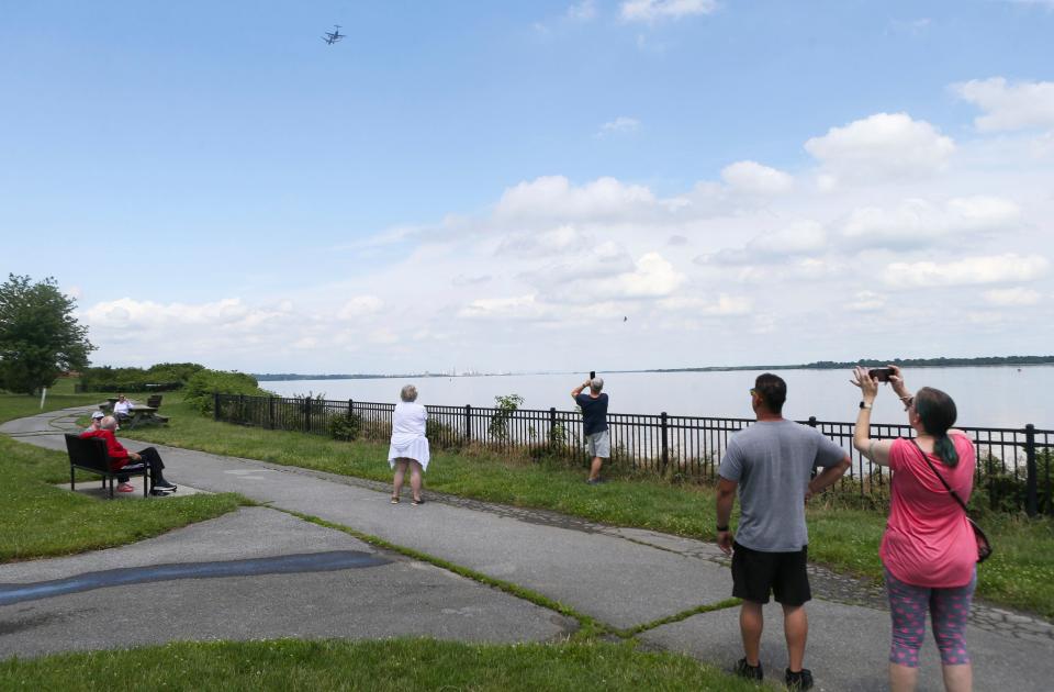 People watch from Fox Point State Park as planes from the US Air Force 305th Air Mobility Wing fly in close formation up the Delaware River as they participate in two waves of flyovers to mark 100 years of air refueling, Tuesday, June 27, 2023.