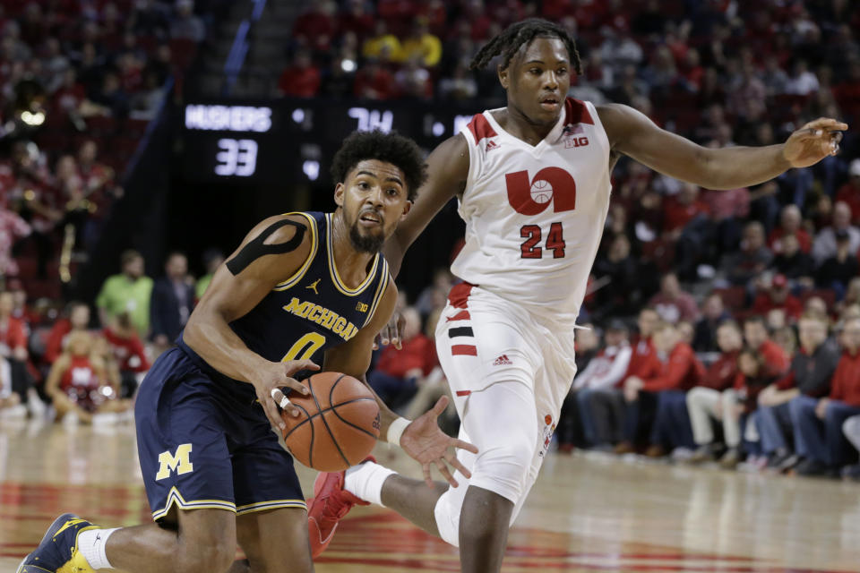 Michigan's David DeJulius (0) drives around Nebraska's Yvan Ouedraogo (24) during the first half of an NCAA college basketball game in Lincoln, Neb., Tuesday, Jan. 28, 2020. (AP Photo/Nati Harnik)