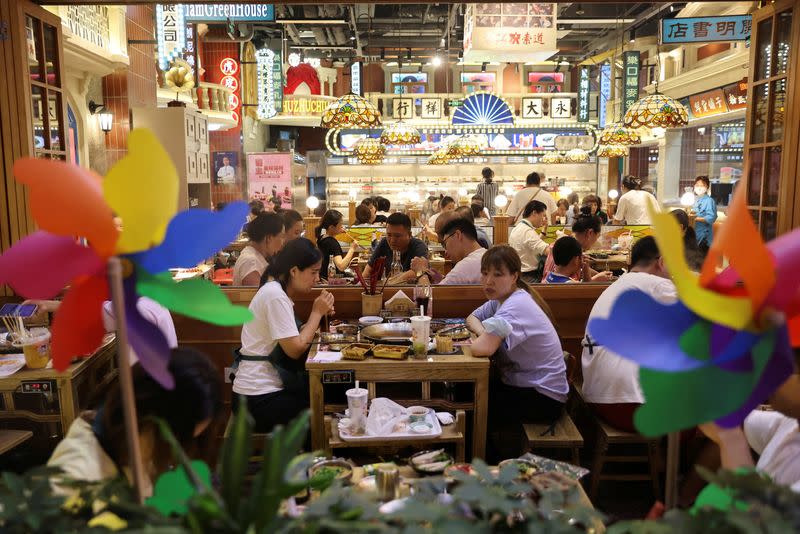 FILE PHOTO: Customers dine at a restaurant in a shopping area in Beijing