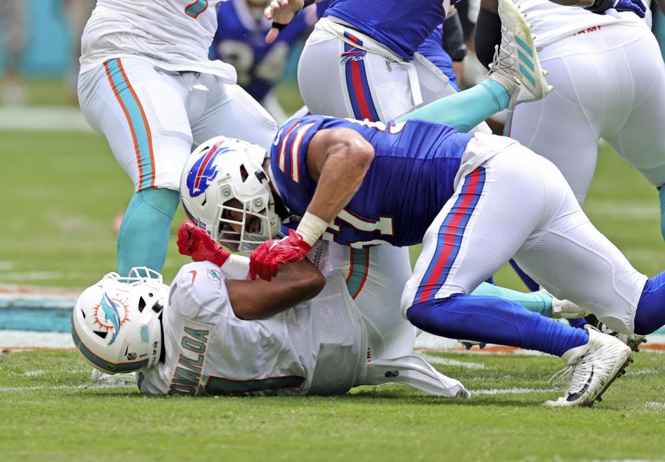 Miami Dolphins quarterback Tua Tagovailoa (1) is sacked by Buffalo Bills defensive end A.J. Epenesa (57) during first half of an NFL football game, Sunday, Sept. 19, 2021, in Miami Gardens, Fla. Tagovailoa was injured on the play. (David Santiago/Miami Herald via AP)