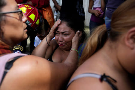 Family members react as they wait for news of their loved ones after a fire broke at the Virgen de Asuncion home in San Jose Pinula, on the outskirts of Guatemala City, Guatemala. REUTERS/Saul Martinez