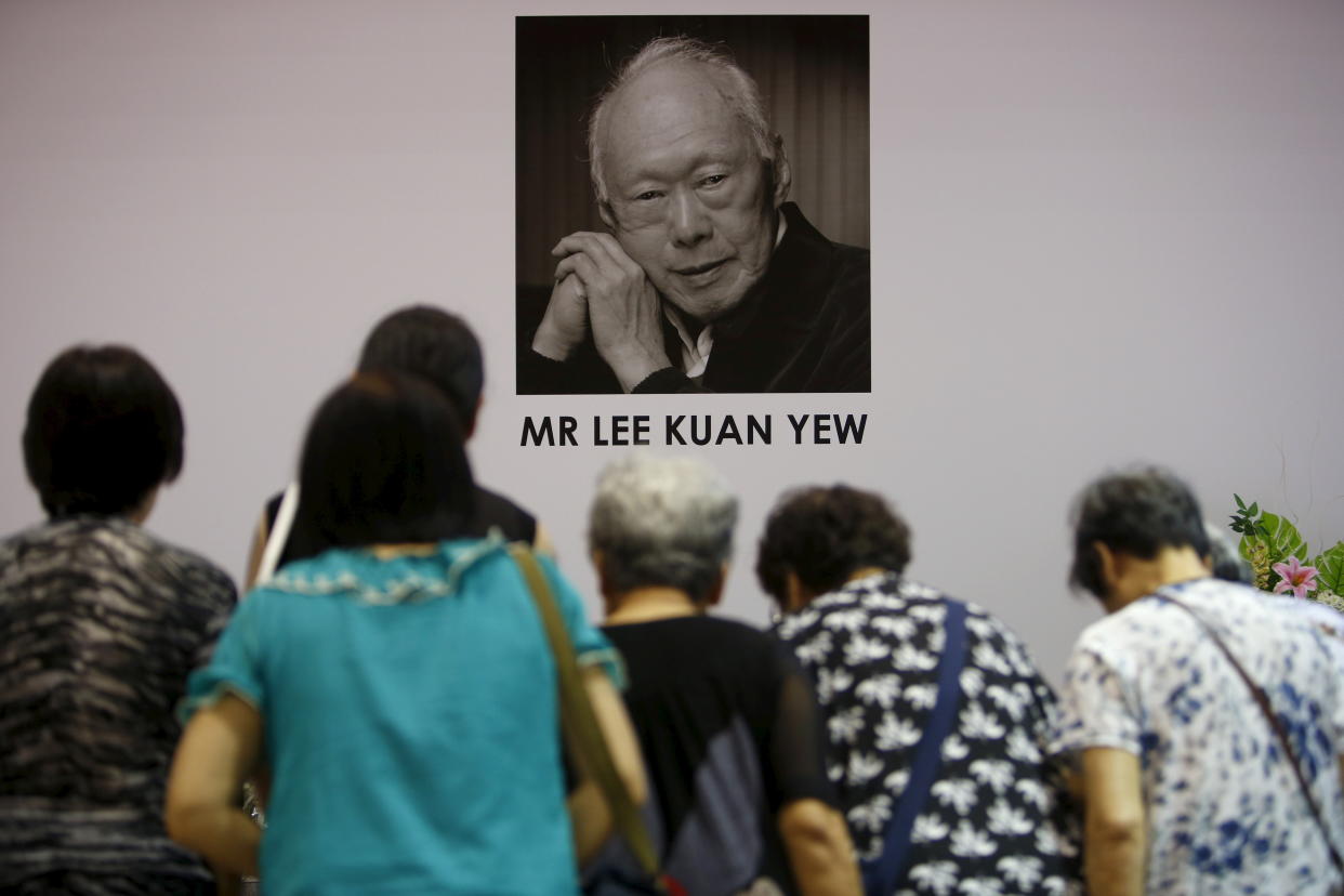 People bow as they pay their respects to the late former prime minister Lee Kuan Yew at Tanjong Pagar community club, in the constituency which Lee represented as Member of Parliament since 1955, in Singapore March 23, 2015.  Lee, Singapore's first prime minister and architect of the tiny Southeast Asian city-state's rapid rise from British tropical outpost to global trade and financial centre, died early on Monday, aged 91, the Prime Minister's Office said. REUTERS/Edgar Su 