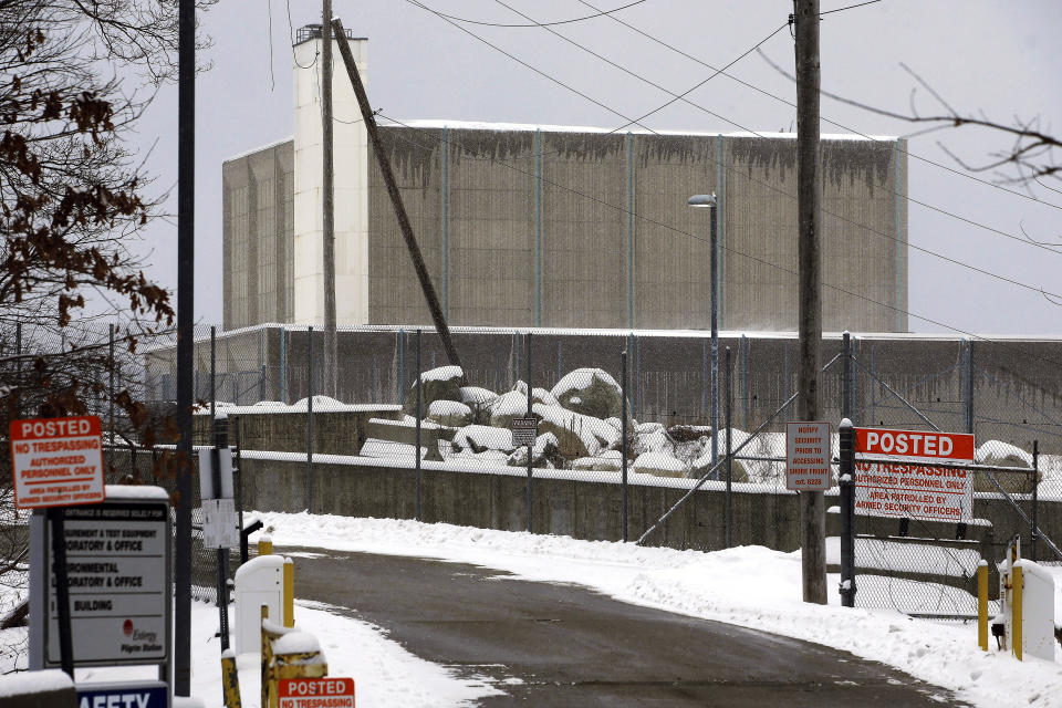 FILE - A no trespassing sign is posted near the entrance to the Pilgrim Nuclear Power Station, at rear, Thursday, Feb. 28, 2019, in Plymouth, Mass. One million gallons of radioactive water is contained inside the former nuclear power plant along Cape Cod Bay. The plant's owner, Holtec International, is considering treating the water and discharging it into the bay. Local residents, shell fishermen and politicians disapprove of the plan. (AP Photo/Steven Senne, File)