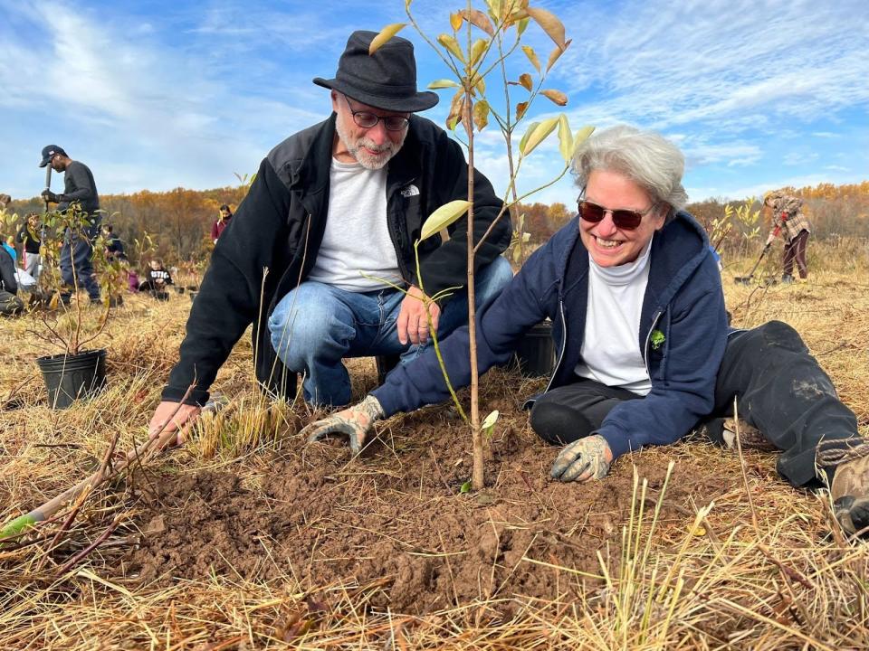 Former Montgomery Mayor Louise Wilson and Cliff Wilson, the former president of the Sourland Conservancy board, plant the 10,000th tree the Sourland Conservancy has planted in 2021