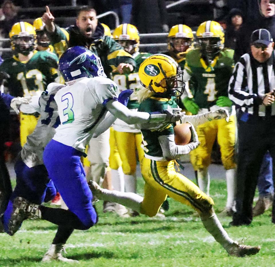 South Shore running back Todd Egan runs for a first down in the fourth quarter and was tackled by Blue Hills Regional High School's Marcus Griffin during a game on Thursday, Nov. 17, 2022.  