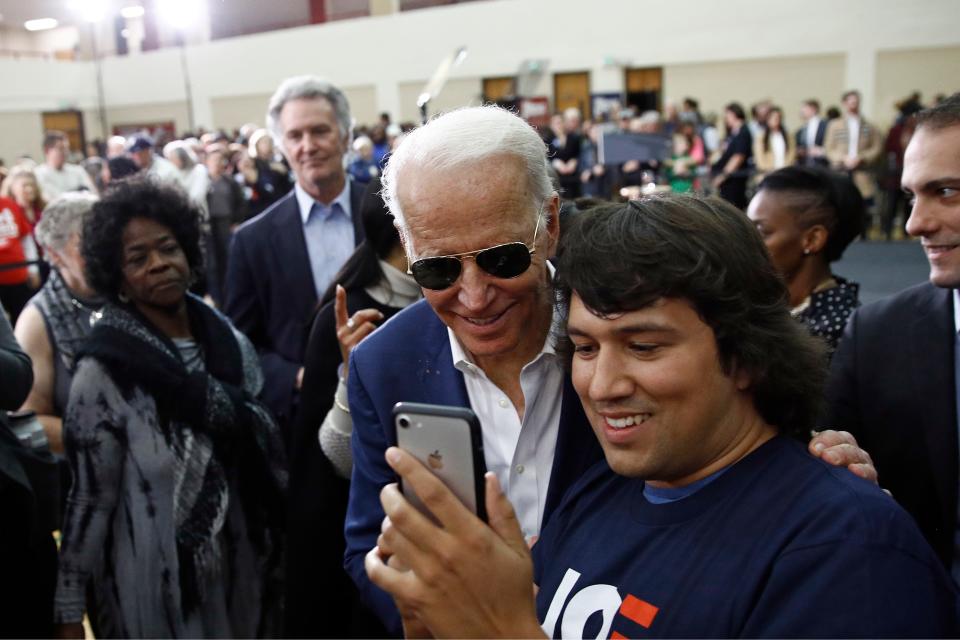 Former Vice President Joe Biden poses for a photo with an attendee after speaking at a campaign event, Monday, Feb. 24, 2020, in Charleston, S.C.