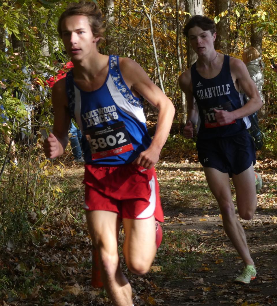 Lakewood senior Corey Rafferty leads Granville senior Eli Kretchmar through the woods during the Licking County League championships at Watkins Memorial on Saturday, Oct. 15, 2022. Rafferty was the overall and Cardinal Division champion with Kretchmar taking the Buckeye title.