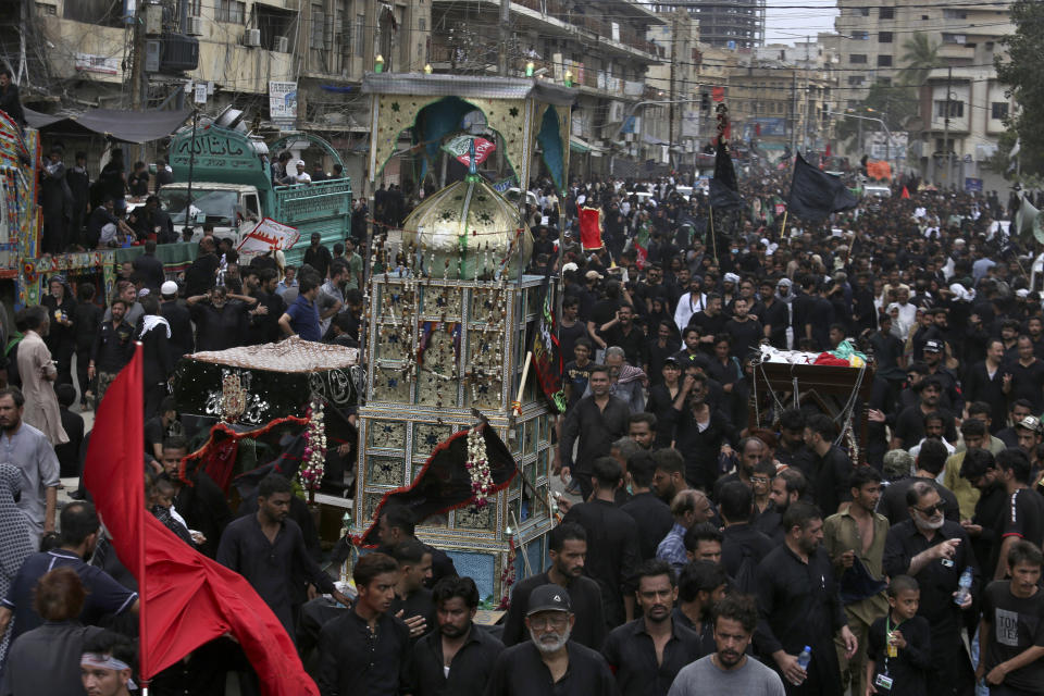 Shiite Muslims participate in a procession to mark Ashoura, in Karachi, Pakistan, Tuesday, Aug. 9, 2022. Ashoura falls on the 10th day of Muharram, the first month of the Islamic calendar, when Shiites mark the death of Hussein, the grandson of the Prophet Muhammad, at the Battle of Karbala in present-day Iraq in the 7th century. (AP Photo/Fareed Khan)