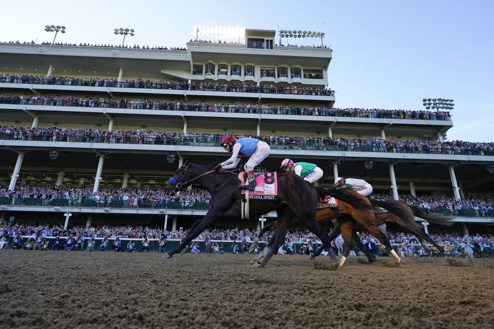 John Velazquez riding Medina Spirit leads Florent Geroux on Mandaloun and Flavien Prat riding Hot Rod Charlie to win the 147th running of the Kentucky Derby at Churchill Downs, Saturday, May 1, 2021, in Louisville, Ky. (AP Photo/Jeff Roberson)