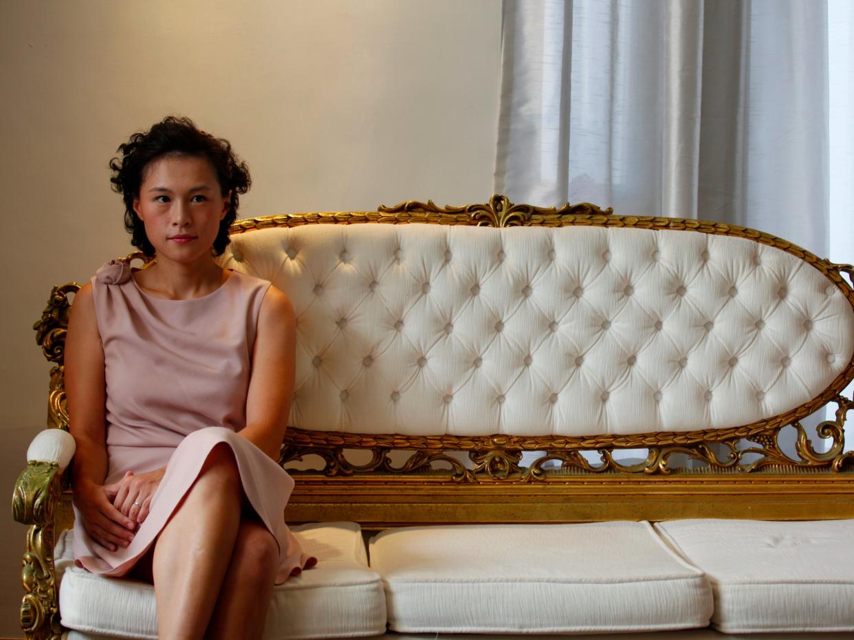 DATE IMPORTED:September 27, 2012Gigi Chao, the daughter of Hong Kong property tycoon Cecil Chao Sze-tsung, poses at the conference room of her office in Hong Kong September 27, 2012. A flood of men offered dates and marriage proposals to the lesbian daughter of Cecil Chao who was willing to pay $500 million HKD ($64 million) to a successful son-in-law. Gigi, who works with her father as the executive director of the family-owned Cheuk Nang Holdings Ltd, told Reuters in an exclusive interview that she saw her father's announcement as an act of love. REUTERS/Bobby Yip