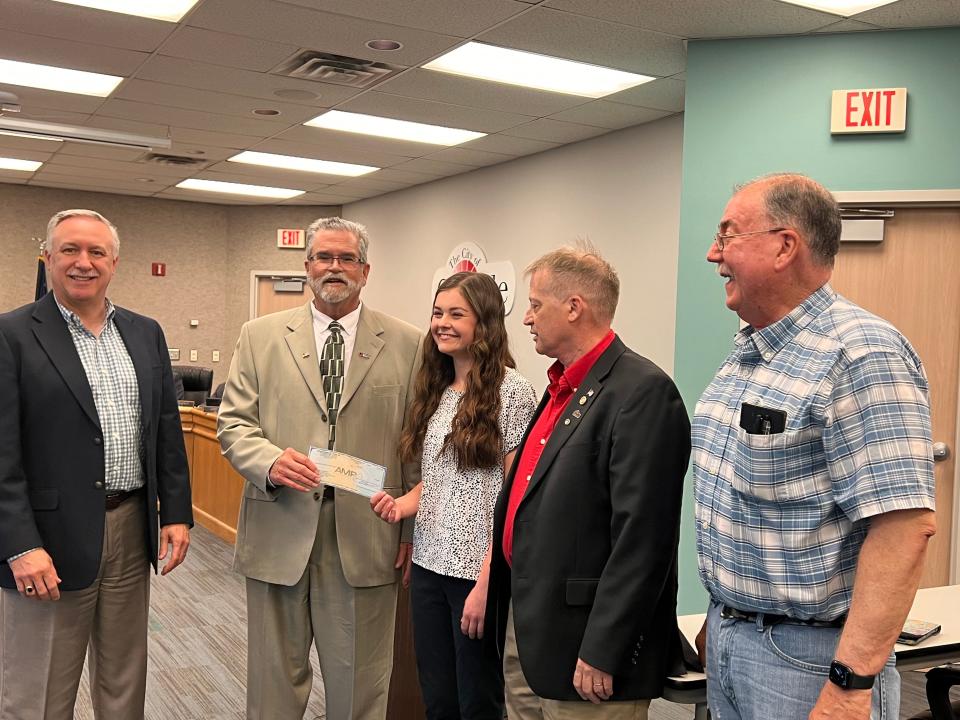 Orrville High School senior Jayne Wallace (center) receives the American Municipal Power Scholarship from (left to right) Jeff Brediger, utilities director; Jay Myers, AMP representative; and Orrville Utilities Board members Rich Corfman and Don McFarlin at Monday's City Council meeting.