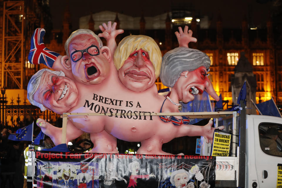 An anti-Brexit effigy is driven around Parliament square after the results of the vote on British Prime Minister Theresa May's Brexit deal were announced in London, Tuesday, Jan. 15, 2019. British lawmakers have rejected Prime Minister Theresa May's Brexit deal by a huge margin, plunging U.K. politics into crisis 10 weeks before the country is due to leave the European Union. The House of Commons voted 432 -202 on Tuesday against the deal struck between Britain's government and the EU in November. (AP Photo/Frank Augstein)