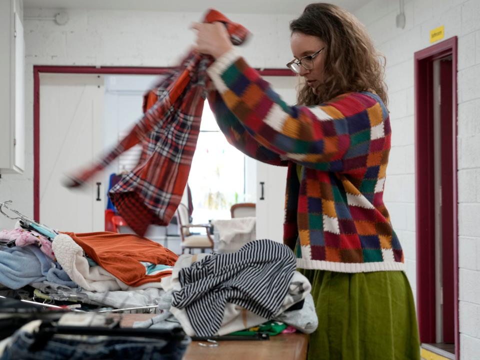 Father Gene’s executive director Jessica Luebbering organizes donated clothing at Father Gene’s Help Center in West Allis on Wednesday, Nov. 1, 2023.