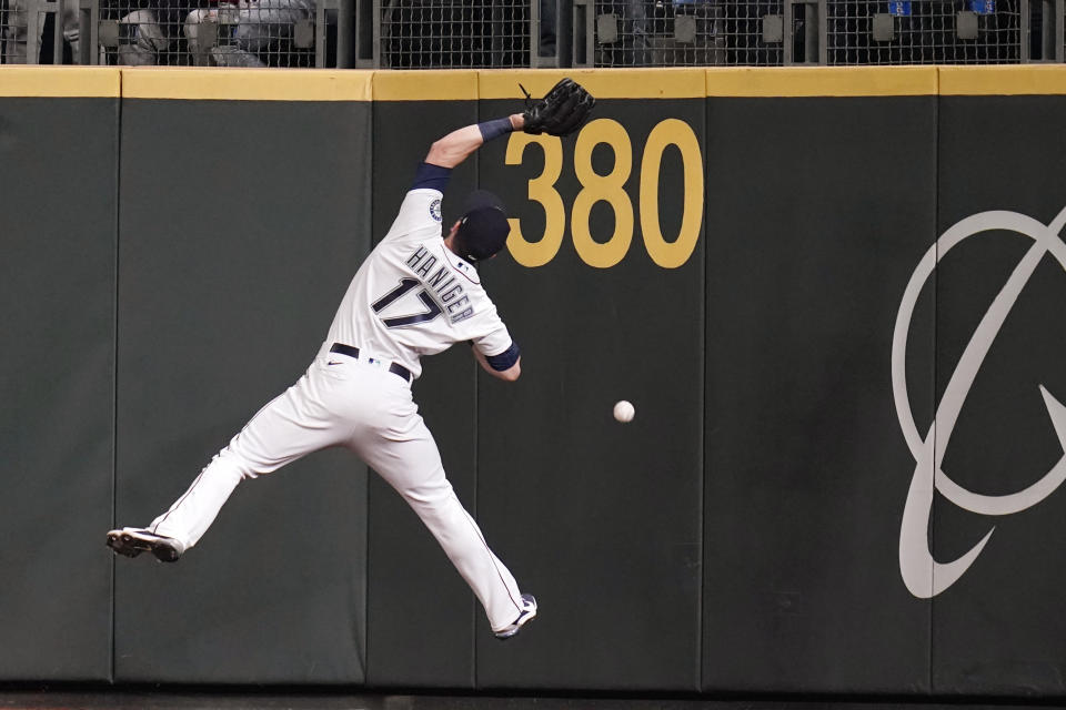 Seattle Mariners right fielder Mitch Haniger can't catch a deep fly ball that fell in for a triple by Boston Red Sox's Xander Bogaerts during the eighth inning of a baseball game Tuesday, Sept. 14, 2021, in Seattle. (AP Photo/Elaine Thompson)