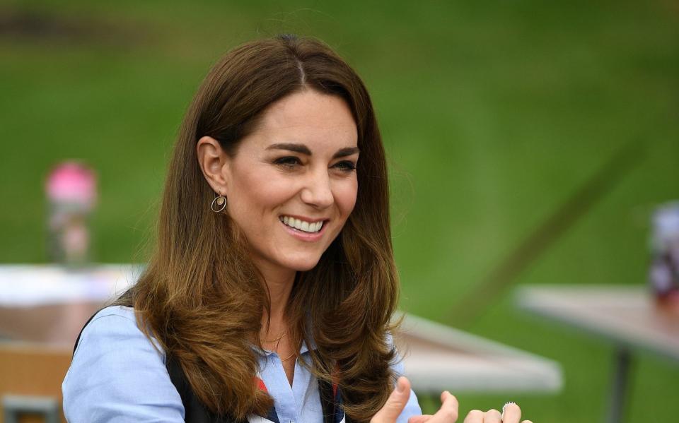 Kate wearing All the Falling Stars gold disc earrings on Monday - AFP