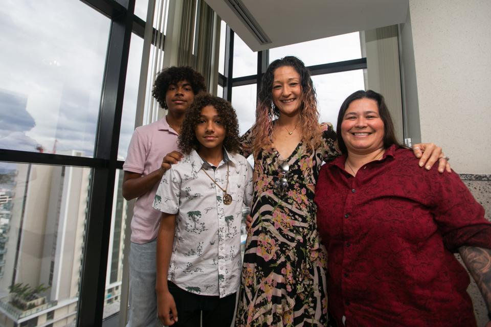 From left, Damion Kingsley, 14, Darryl Bent, 12, and their soon-to-be adoptive parents, Nicole Miller and Cynthia Rodriguez of Palm Beach Gardens, pose for a portrait at the Palm Beach County Courthouse on Friday, November 18, 2022, in downtown West Palm Beach, FL. Twenty-one children were adopted by families at National Adoption Day ceremonies at the Palm Beach County Courthouse.