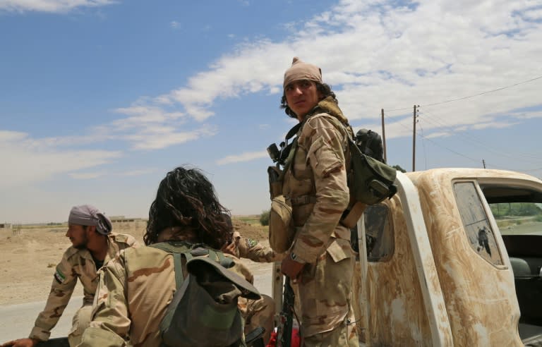 Members of Ahmad Jarba's Syrian Elite Forces, fighting alongside the US-backed Syrian Democratic Forces ride a truck in a neighbourhood on the eastern front of Raqa on June 14