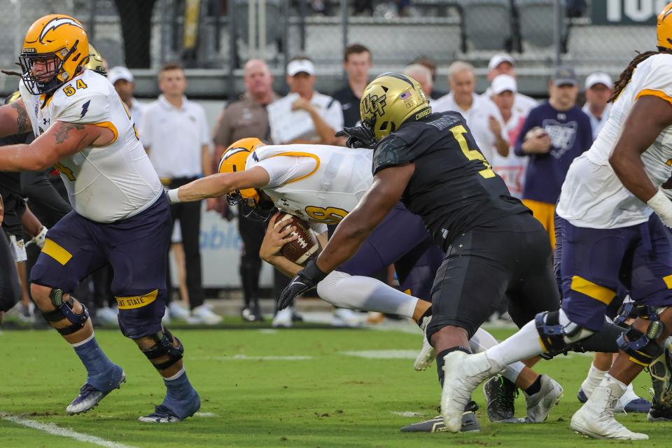 UCF defensive lineman Ricky Barber (5) sacks Kent State quarterback Michael Alaimo in the first quarter on Thursday night.