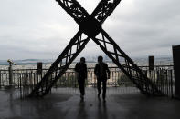 French visitors walk on the second level during the opening up of the third level and top floor of the Eiffel Tower, Wednesday, July 15, 2020 in Paris. The top floor of Paris' Eiffel Tower reopened today as the 19th century iron monument re-opened its first two floors on June 26 following its longest closure since World War II. (AP Photo/Francois Mori)