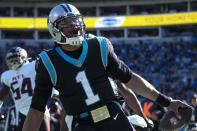Carolina Panthers quarterback Cam Newton celebrates after scoring against the Atlanta Falcons during the first half of an NFL football game Sunday, Dec. 12, 2021, in Charlotte, N.C. (AP Photo/John Bazemore)