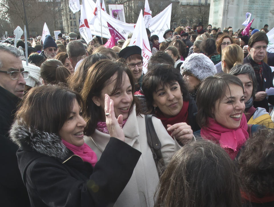 Socialist candidate to be elected mayor of Paris, Anne Hidalgo, left, waves during a really to protest against the new abortion law in Spain, during an event in Paris, Saturday Feb. 1, 2014. Spain's conservative government approved tight restrictions on abortion, allowing the practice only in the case of rape or when there is a serious health risk. (AP Photo/Michel Euler)