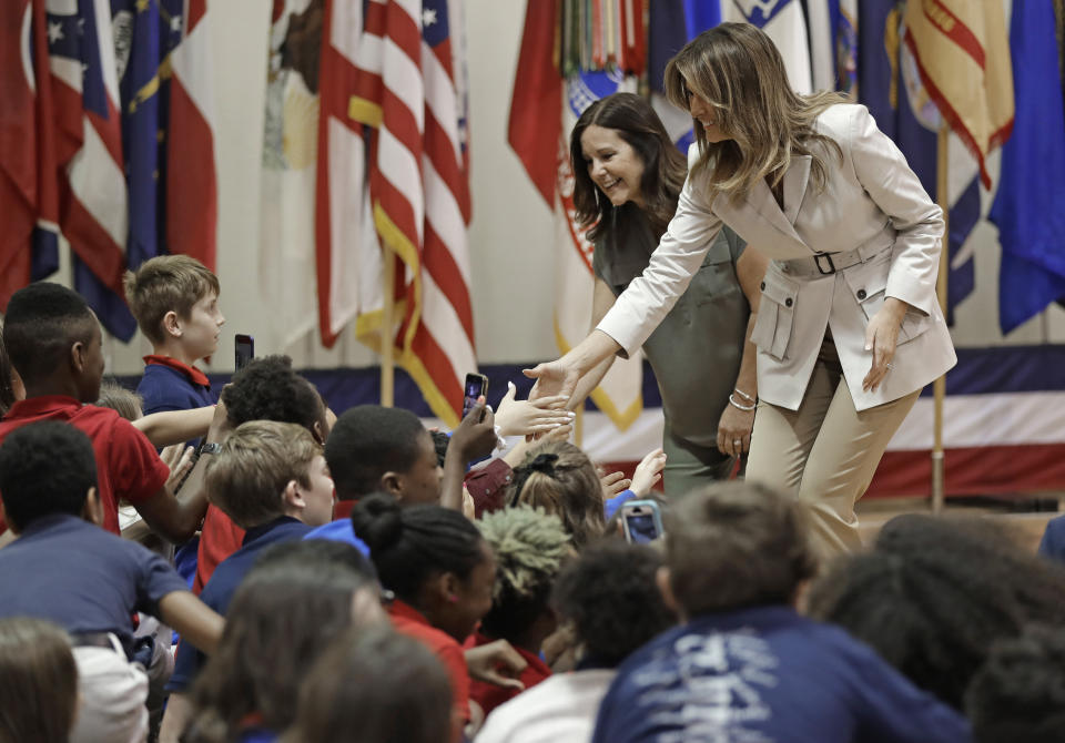 First lady Melania Trump, right, and second lady Karen Pence, left, greet student at Albritton Middle School in Fort Bragg, N.C., Monday, April 15, 2019. (AP Photo/Chuck Burton)