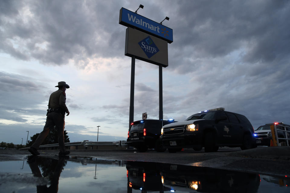 Law enforcement officials block a road early Sunday morning at the scene of a mass shooting that occurred Saturday at a shopping complex in El Paso. (Photo: ASSOCIATED PRESS)