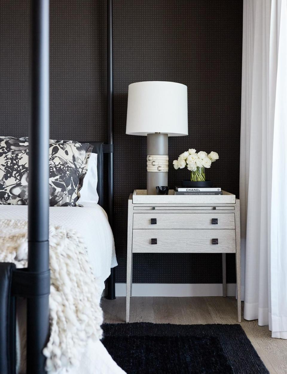 <p>An almost all-black bedroom doesn't have to feel stark, as designer <a href="https://www.chairish.com/shop/jennifer-robin-interiors" rel="nofollow noopener" target="_blank" data-ylk="slk:Jennifer Robin;elm:context_link;itc:0;sec:content-canvas" class="link ">Jennifer Robin</a> proves with this dark-walled sanctuary. White accents balance a black wall and black bed, creating a bedroom that feels as cozy as can be. </p>