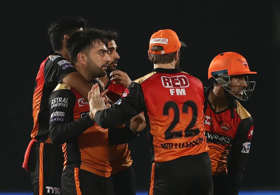 Rashid Khan, left, celebrates taking a wicket (Getty Images)