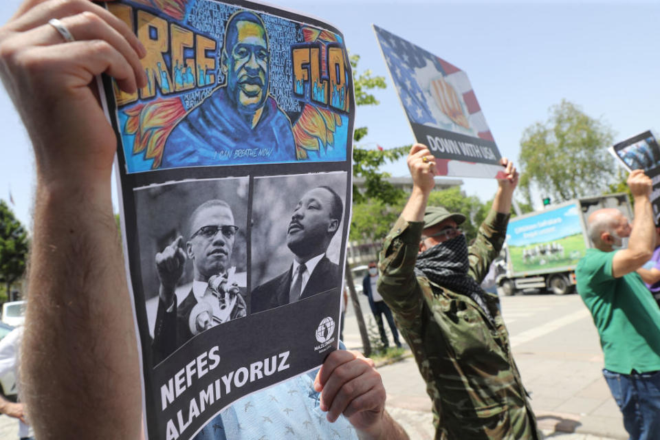 A protester holds a placard bearing the images of George Floyd, Malcom X and Martin Luther King on June 8, 2020, in Ankara, during a demonstration against racism and police brutality<span class="copyright">ADEM ALTAN/AFP via Getty Images</span>