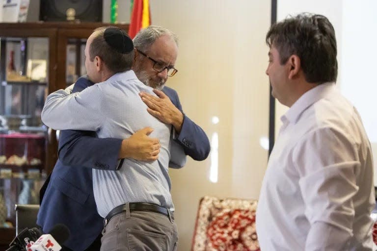 Omar Hernandez, left, hugs Rabbi Ben Zeidman after they sign a joint statement along with Lufti Dagci that asks the El Paso community to reject hate and prejudice on Thursday.