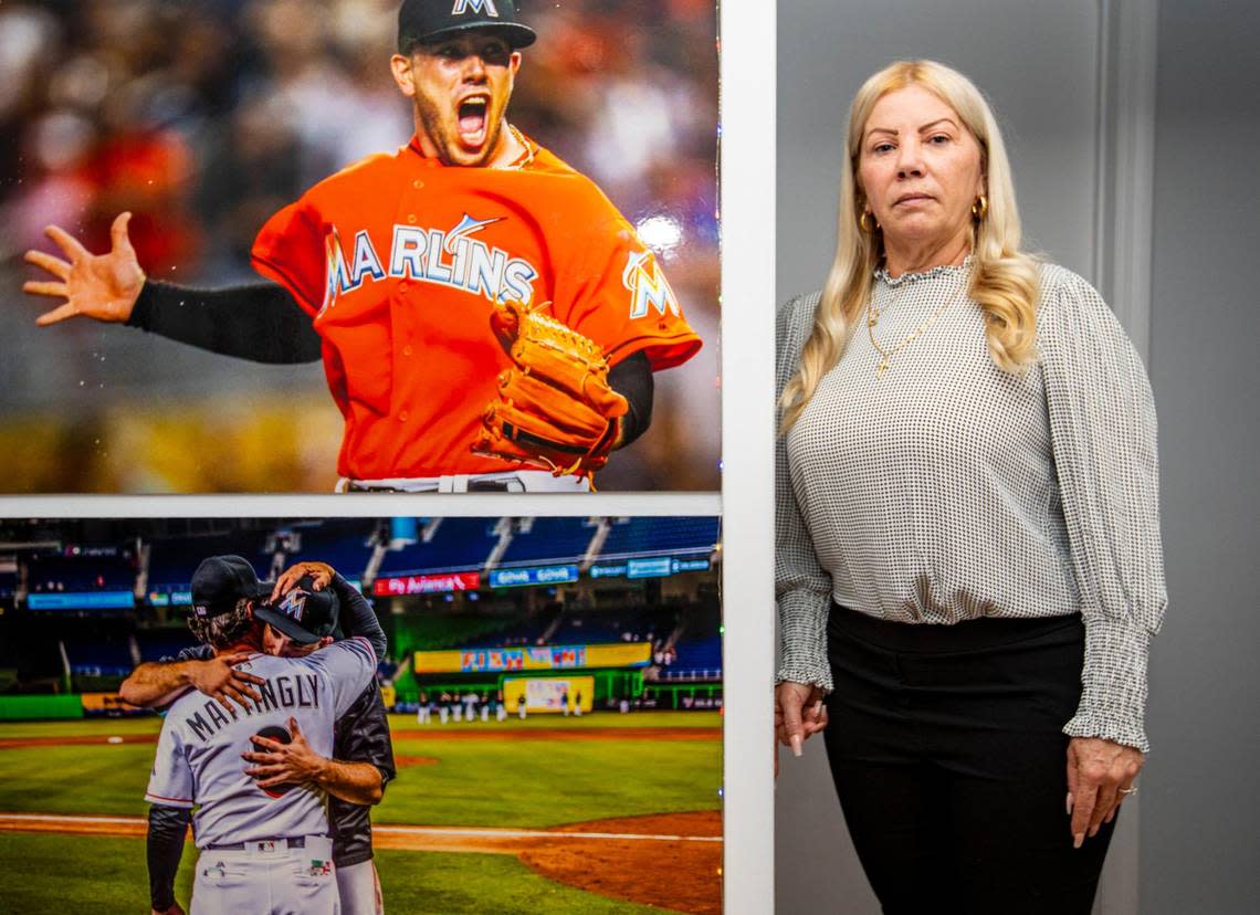 Maritza Gomez Fernandez poses next to mounted pictures of her son, Jose Fernandez, former Marlins ace pitcher and MLB All-Star, at the Fernandez residence in Miami on Sept. 15, 2021. She reflects on the past five years as the anniversary of her son’s death in a boat crash on Sept. 25, 2016, draws near.